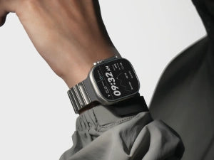 AULUMU titanium Apple Watch band on wrist paired with a digital watch display.