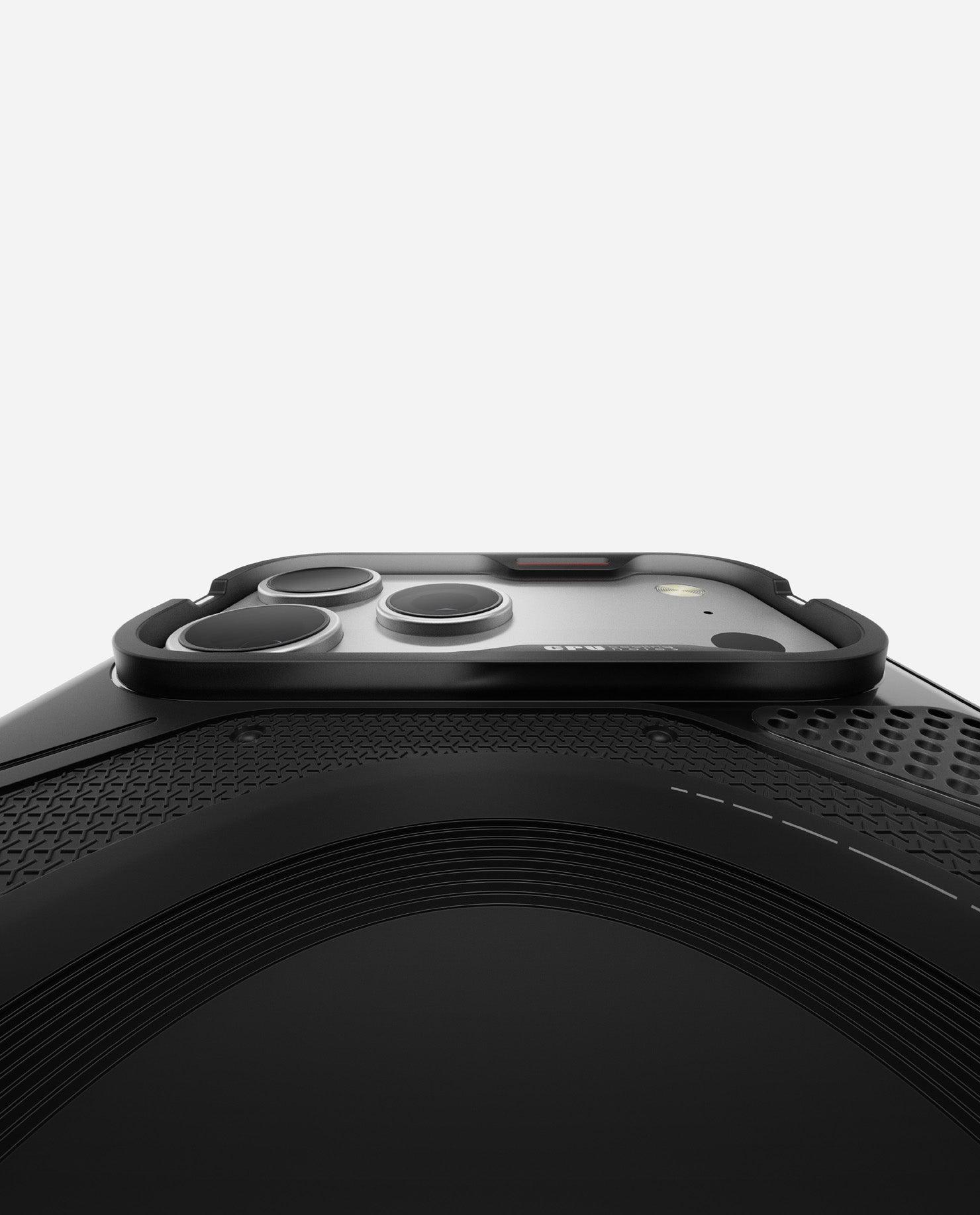 Low-angle shot of AULUMU A17 rugged outdoor case highlighting raised TPU bezel around the iPhone 17 Pro / Pro Max camera