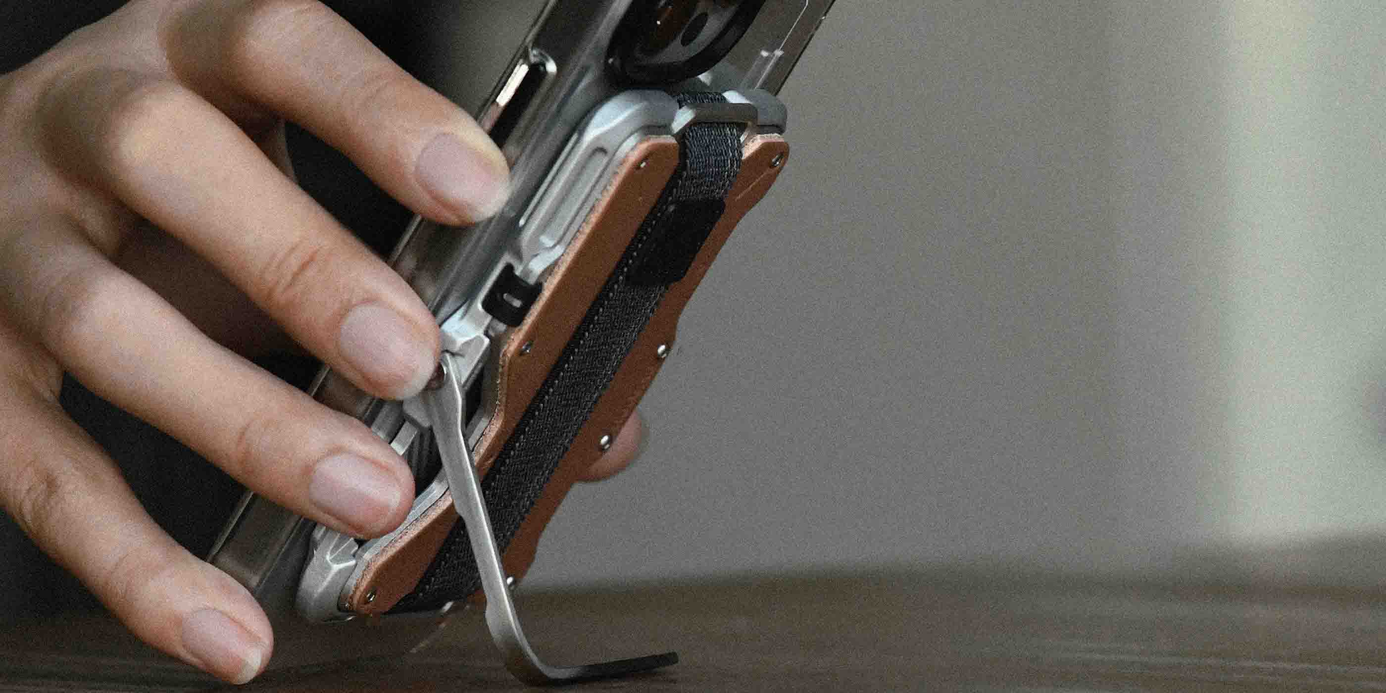 AULUMU G03 MagSafe metal wallet on iPhone used as stand with tool