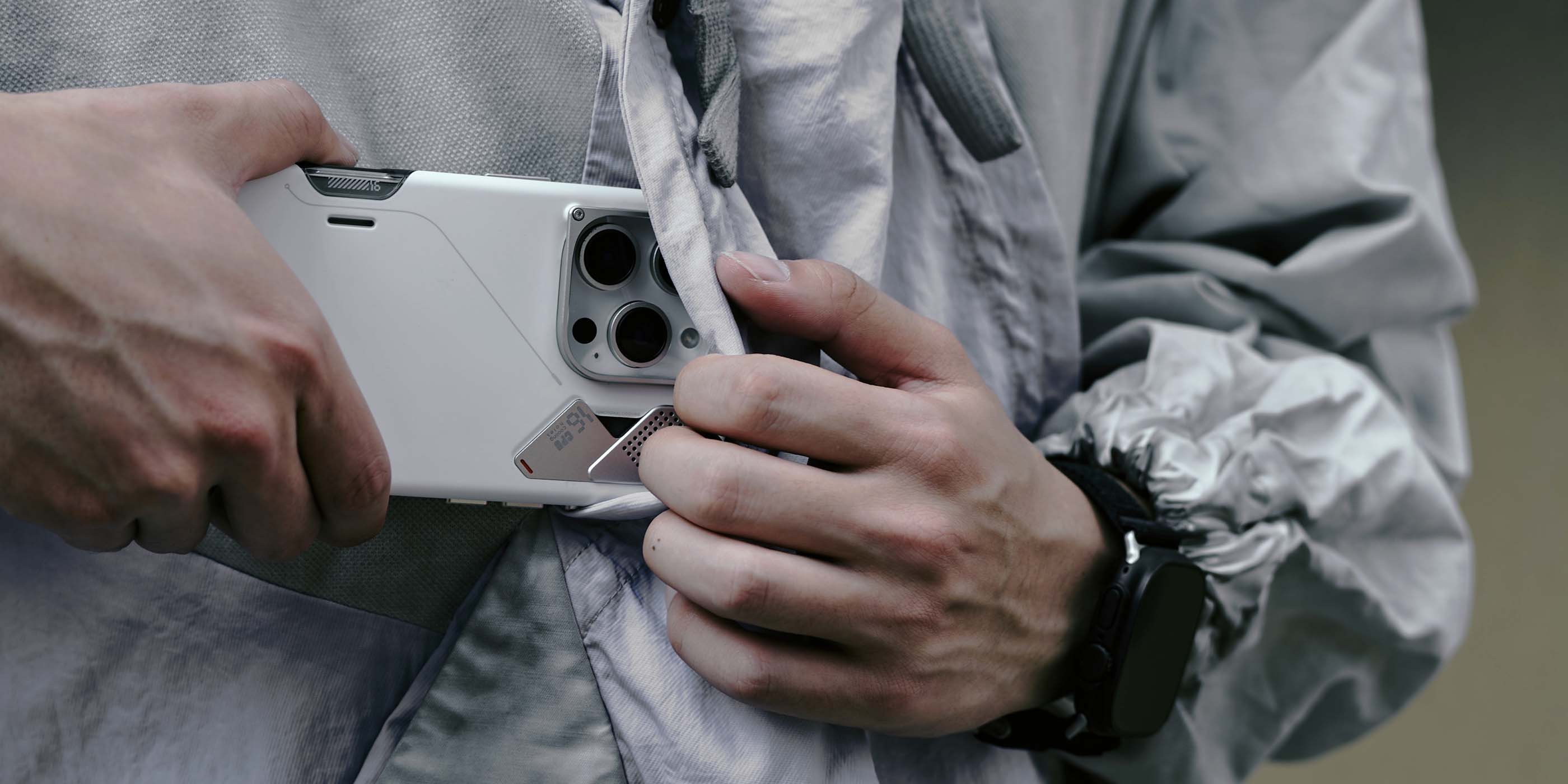 AULUMU A16 slim shockproof case for iPhone 16 Pro with real cooling and camera control cover being put into jacket pocket