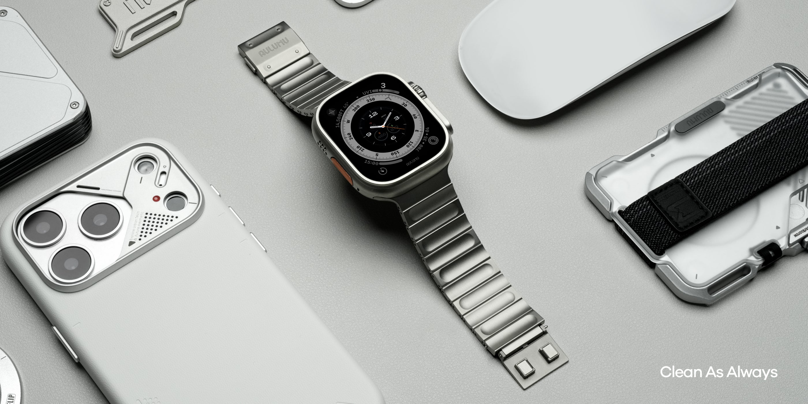 Flat lay of AULUMU C01 titanium band watch with matching AULUMU phone and accessories in a clean desk setup