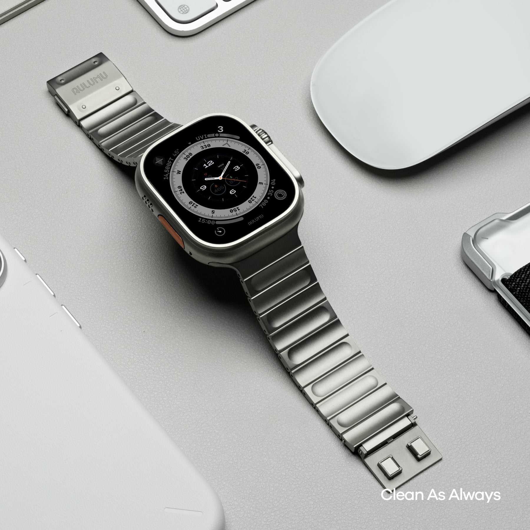 Flat lay of AULUMU C01 titanium band watch with matching AULUMU phone and accessories in a clean desk setup